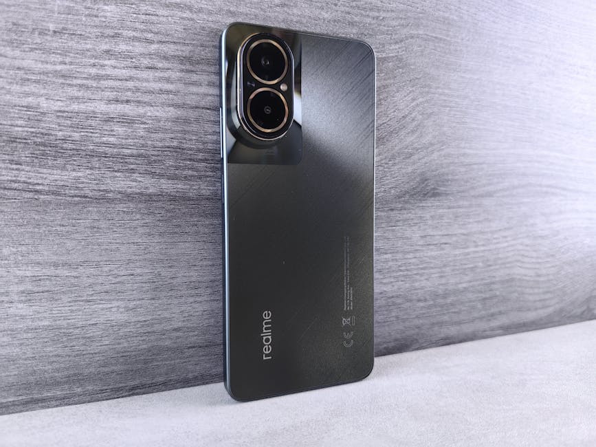Close-up of a modern Realme smartphone with dual cameras on a wooden background.